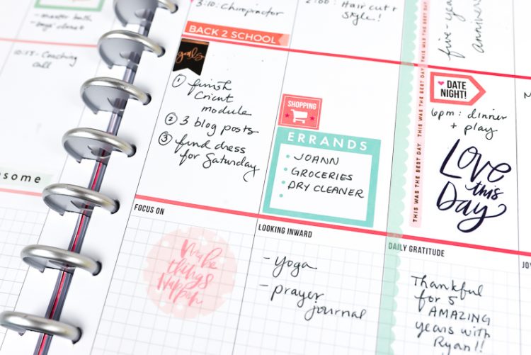 A close up of a weekly planner with stickers