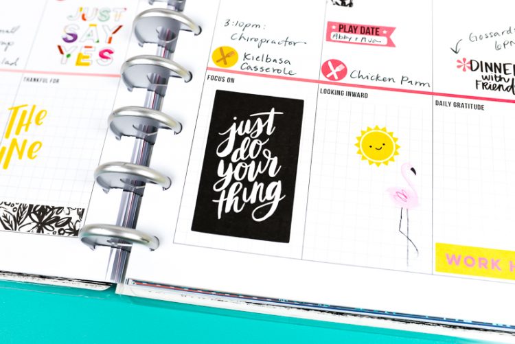 A close up of a weekly planner with stickers