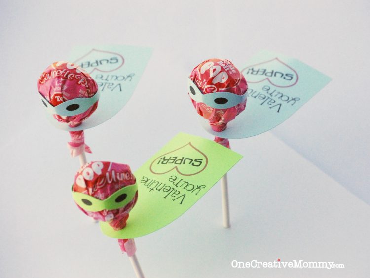 Tootsie pops decorated with superhero masks and a tag that says, \"Valentine You\'re Super\"