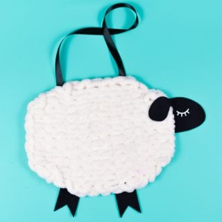 Have you tried loop yarn? Use this super-soft Bernat Alize Blanket-EZ yarn to knit without needles! Use it to create this adorable nursery decor: a yarn and felt sheep wall hanging!