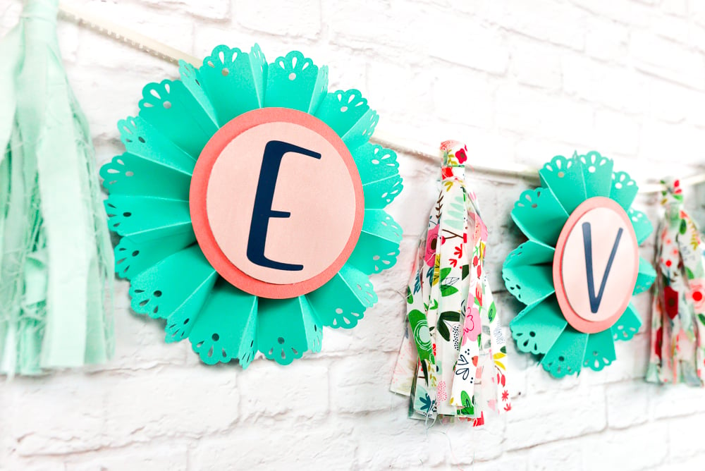 Close up of a baby shower banner made with fabric and craft paper