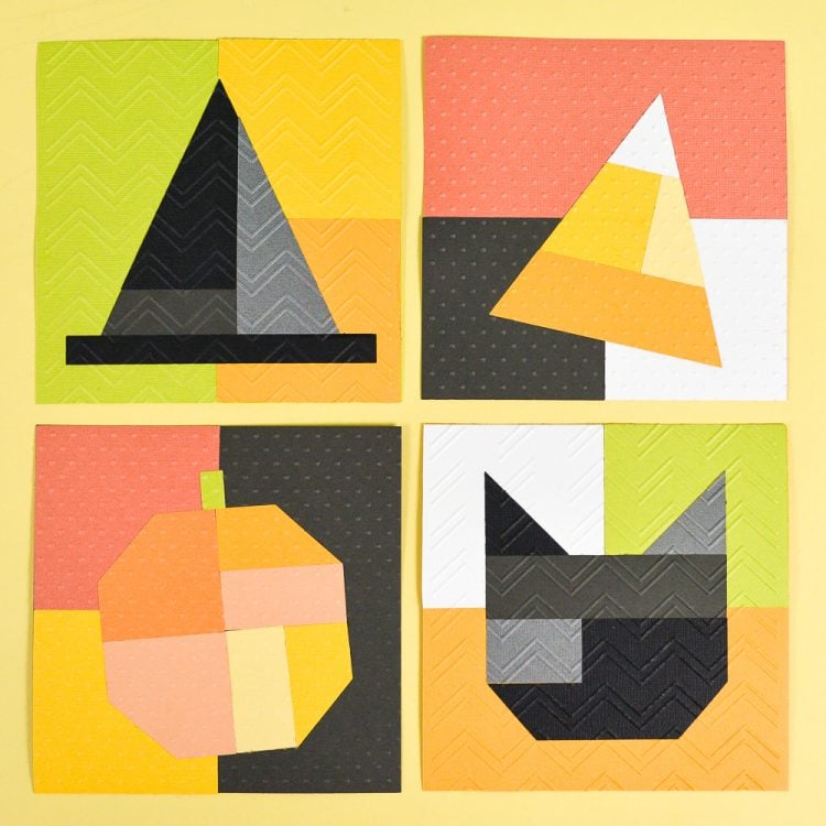 Craft paper cut into different shapes such as a witch\'s hat, a piece of candy corn candy, a pumpkin and a black cat