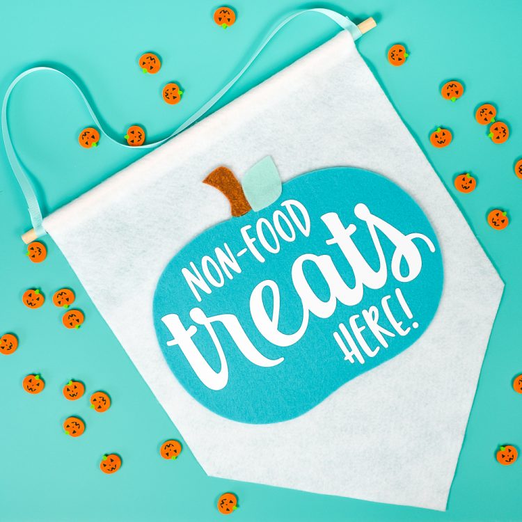 Banner that says, \"Non-Food Treats Hear!\" surrounded by little pumpkin candies