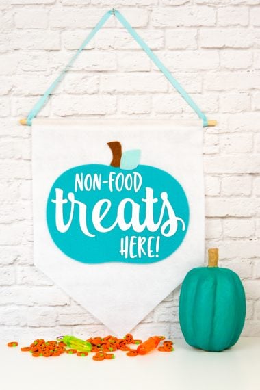 Teal pumpkin next to a hanging banner that says, "Non-Food Treats Hear!"