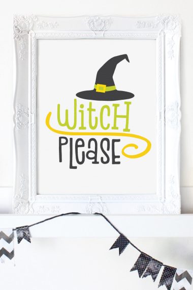 A white framed picture sitting on a mantel and the picture has a witch's hat on it and says, "Witch Please"