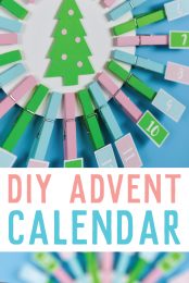 An Advent Calendar made from clothespins and cardstock with advertisement from HEYLETSMAKESTUFF.COM for a DIY Advent Calendar