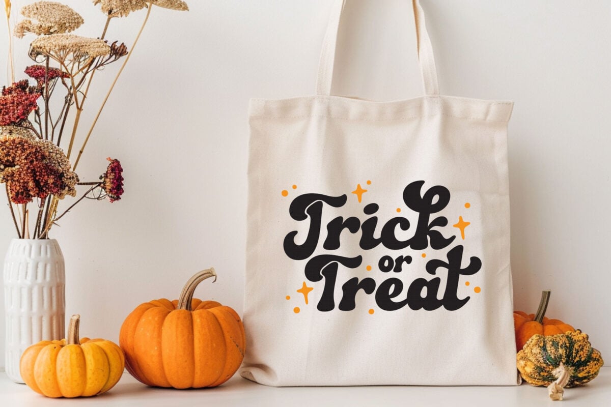 Trick or Treat SVG on a tote bag with pumpkins