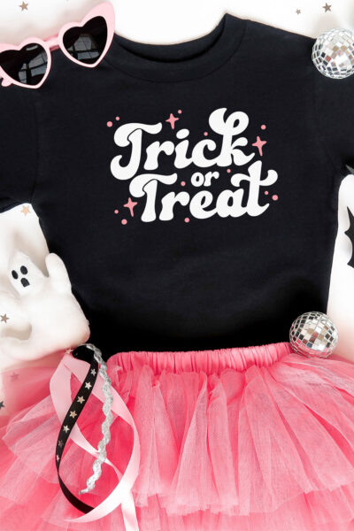 Trick or Treat SVG on a black tee with girlie halloween accessories