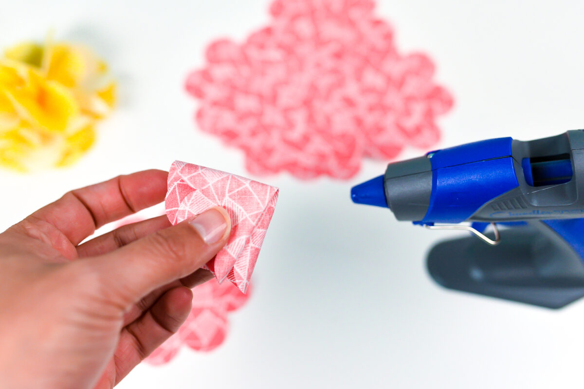 Hot glue to the base of each flower petal