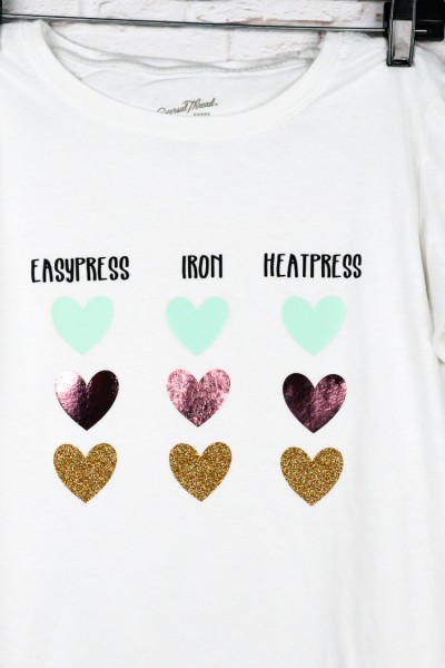White t-shirt hanging from a hanger with images of three vertical rows of hearts each row with a title of "Easypress", "Iron" and "Heatpress"