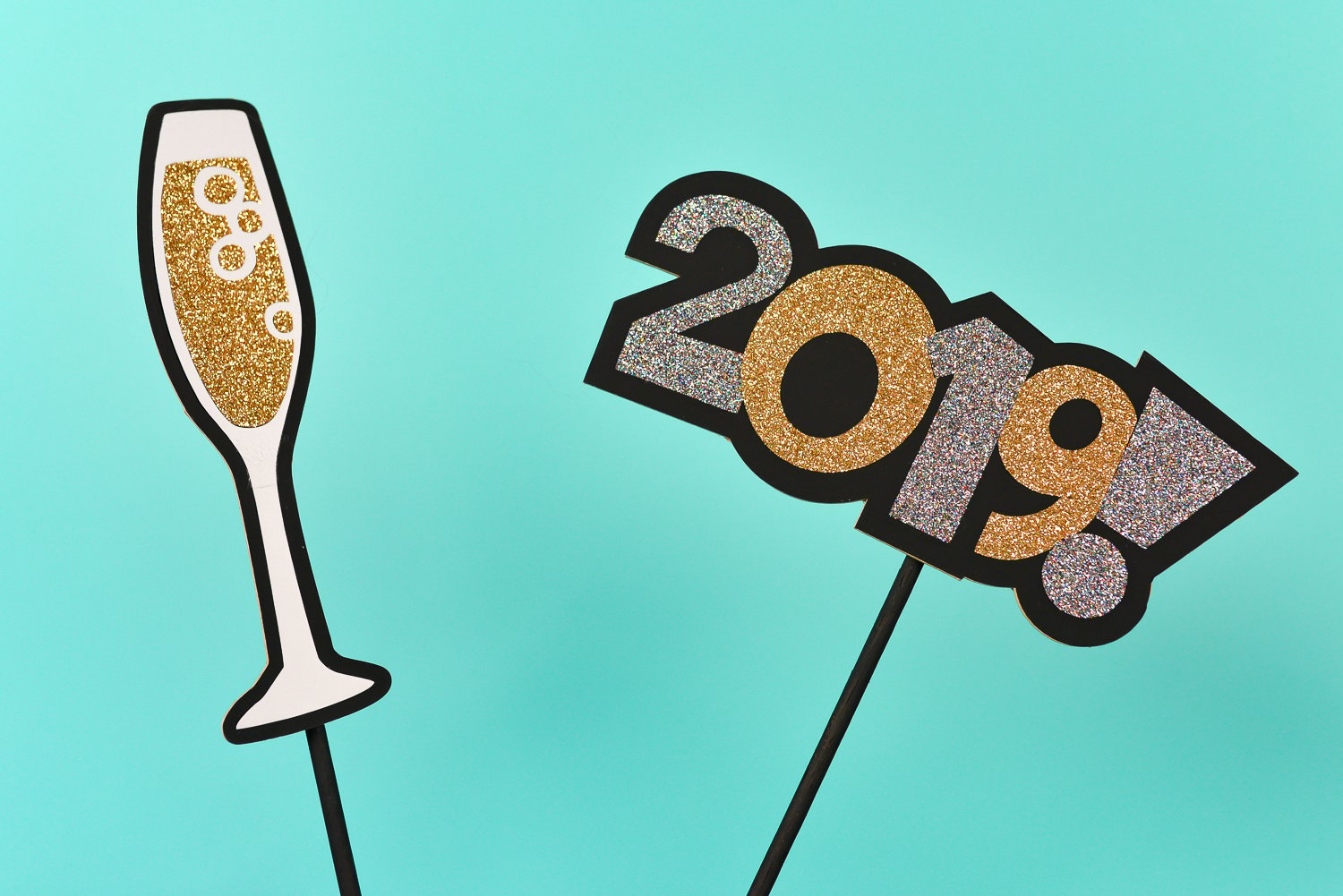 New Year\'s Eve photo booth props made from chipboard of a champagne glass and the year 2019