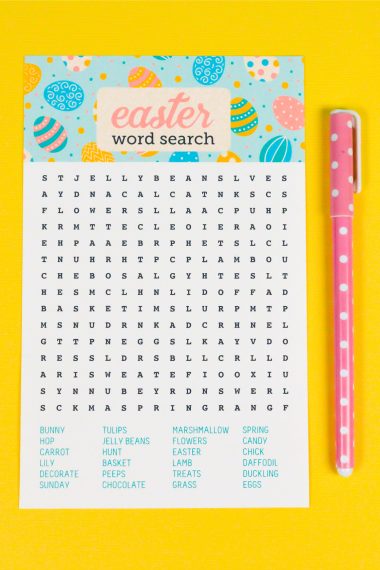 A pink polka dotted pen sitting next to an Easter Word Search paper