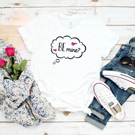 White t-shirt decorated with a thought bubble that says Be Mine