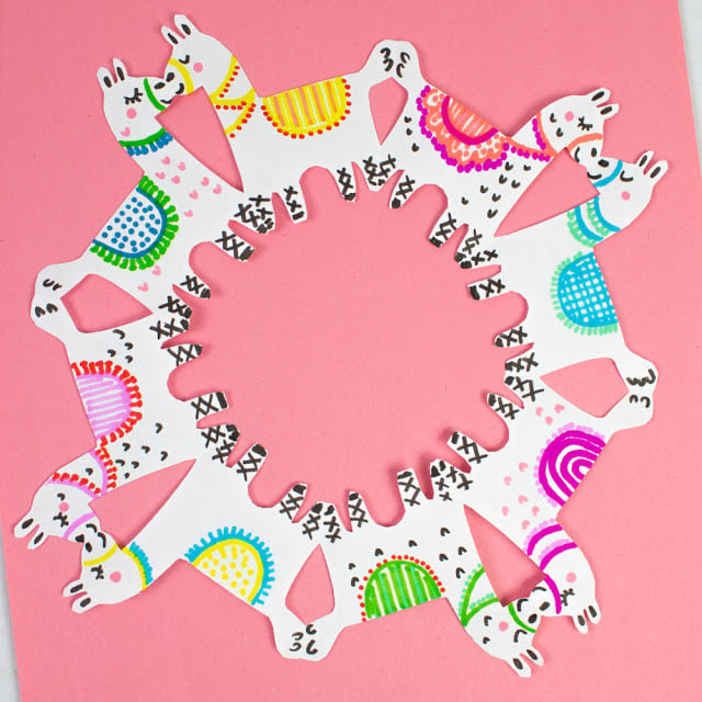 Llama images cut out to look like a wreath or a snowflake