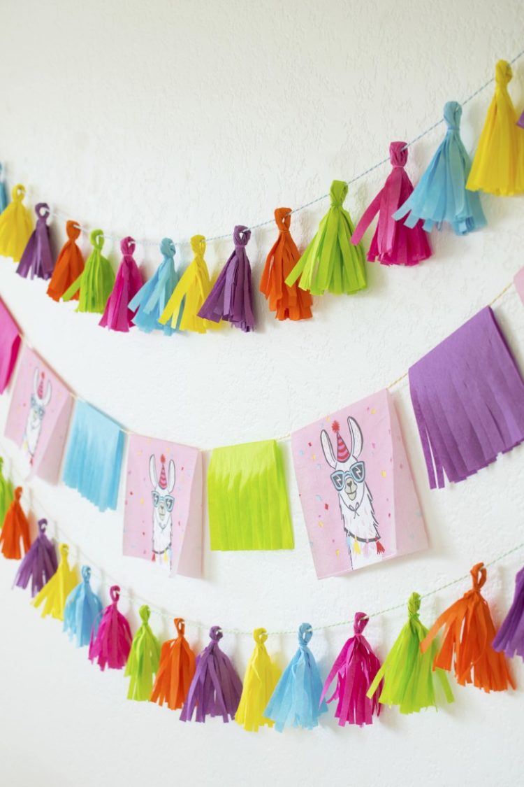 A fringed garland and tassel banner that contains pictures of a llama