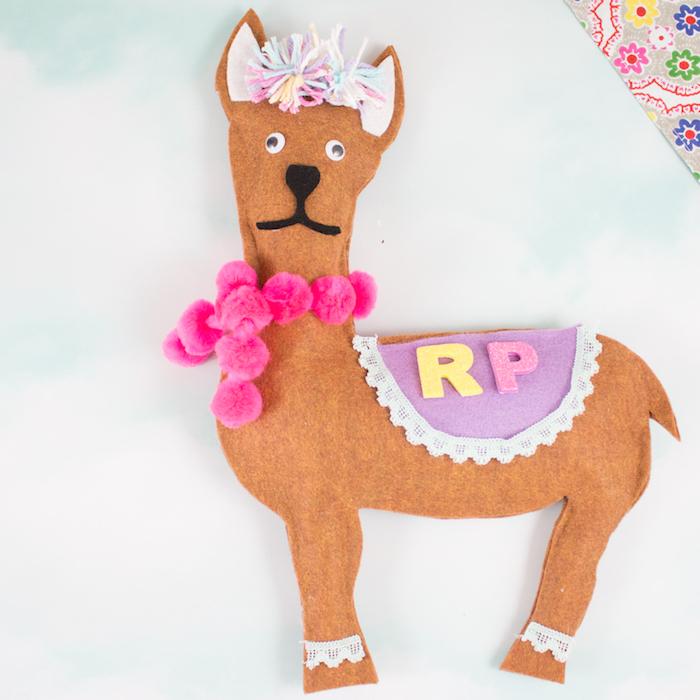A llama made from and decorated with felt