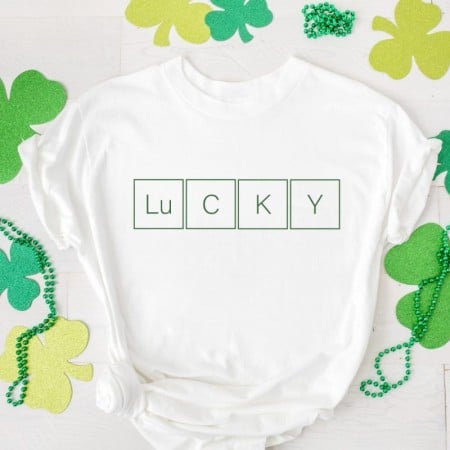 White t-shirt with the word Lucky spelled out with blocks
