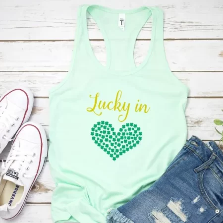 Mint green tank top with a sparkly green heart on it and the words Lucky in