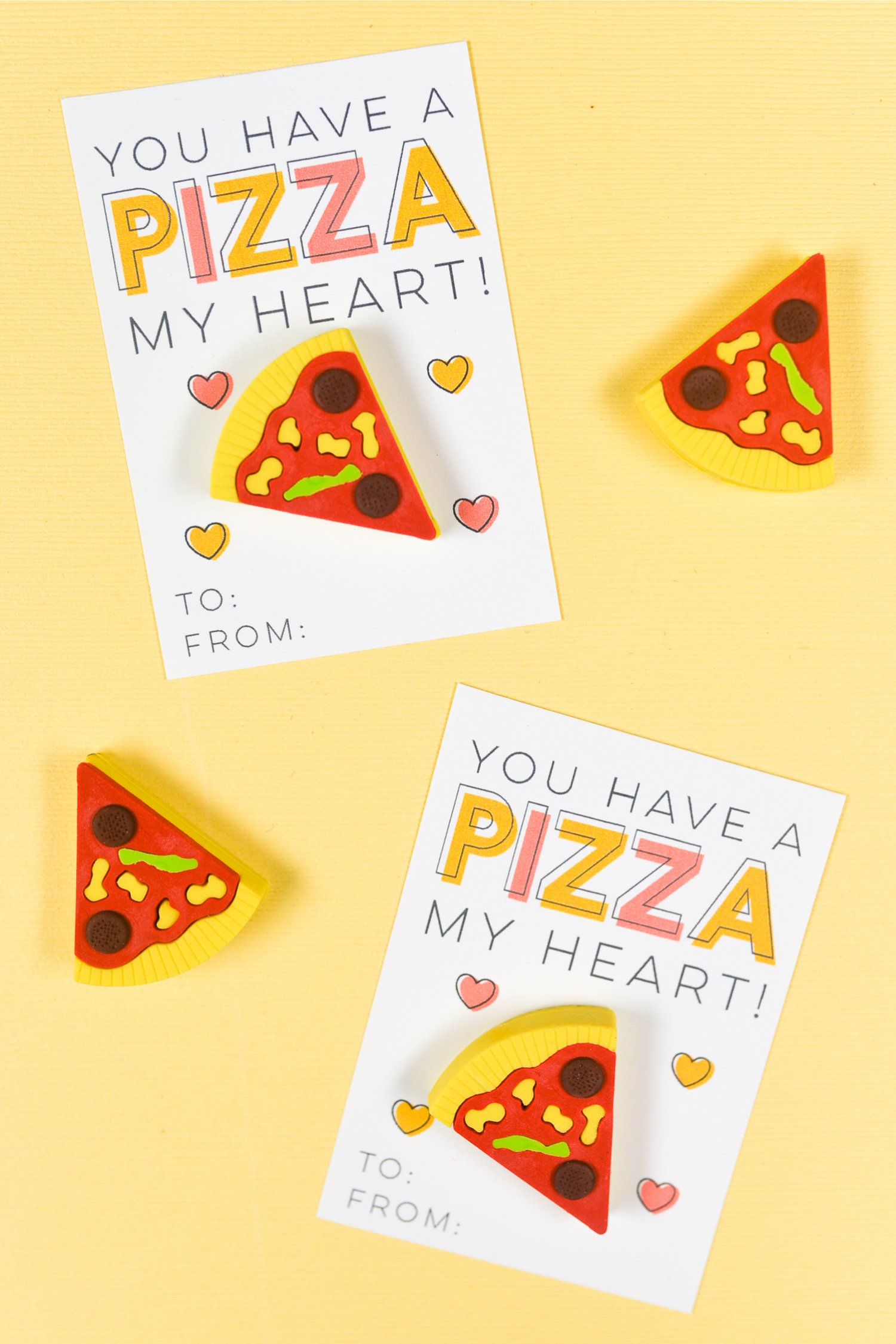 Two Valentine\'s Day cards with a piece of fake pizza on them and the saying, 
\"You Have a Pizza My Heart\"