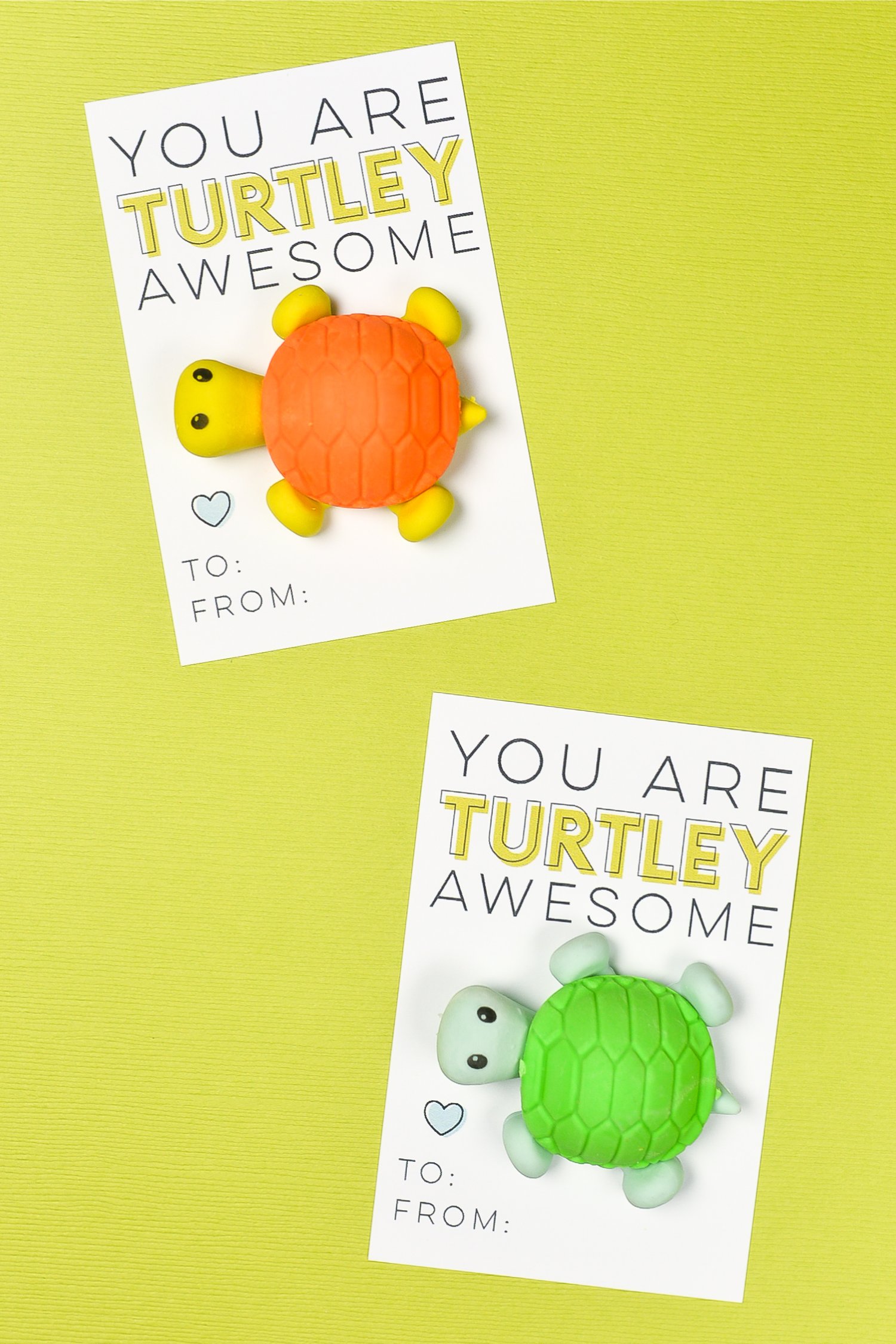 Two Valentine cards, one with a yellow and orange toy turtle attached to it and the other one with a green and blue toy turtle and both say, \"You Are Turtley Awesome\"