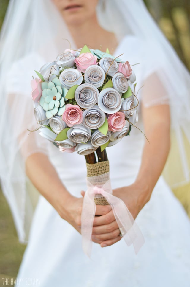 A bride holding a bouquet of paper cut flowers