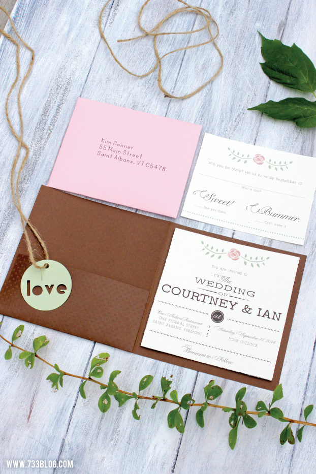 An image of a Wedding invitation laying on a table that includes the addressed envelope and the RSVP card