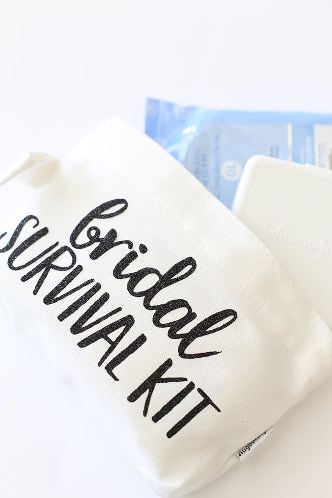 A small canvas bag decorated with the words \"bridal survival kit\" on it