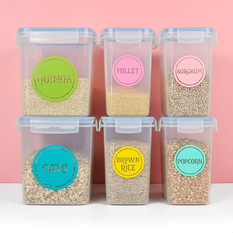 Stacked containers of pantry food staples labeled with colorful labels
