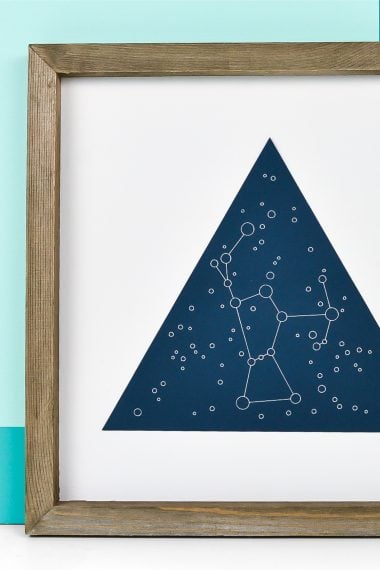 A wooden framed picture of the Orion constellation