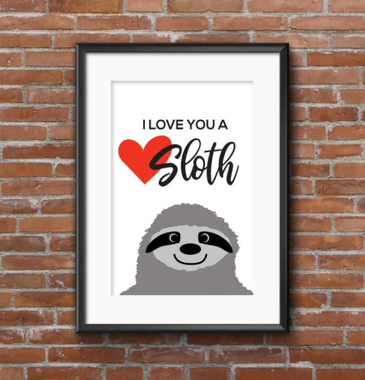 Hanging on a brick wall, a black framed sign with an image of a sloth and says, \"I Love You a Sloth\"
