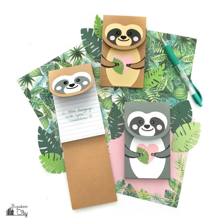 A pen and three sloth decorated notepads