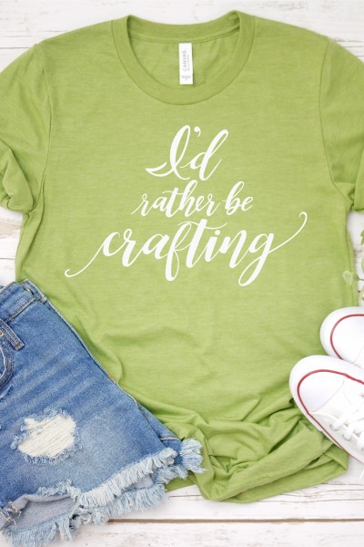 Tennis shoes, blue jean shorts and a lime green shirt with the saying, "I'd Rather be Crafting"