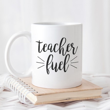 White coffee mug with the saying Teach Fuel on it