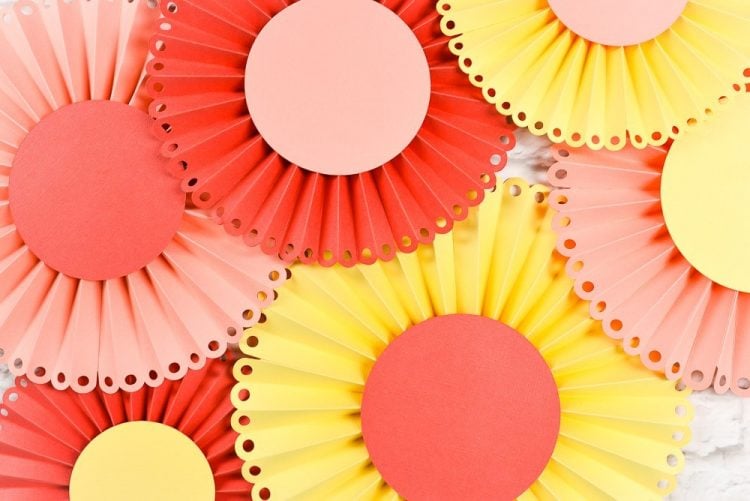 Make these beautiful Paper Rosettes from heyletsmakestuff.com using your Cricut! Pick your favorite colors and add some bridal shower pop.