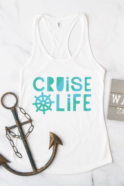 A partial wooden sign, a boat anchor and a white tank top that says, "Cruise Life"