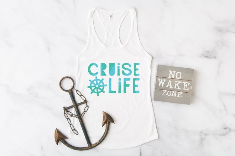 A wooden sign that says, \"No Wake Zone, a boat anchor and a white tank top that says, \"Cruise Life\"