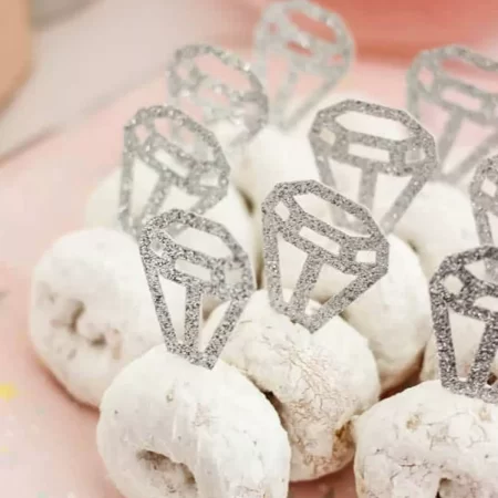 Donuts with glitter paper diamonds to look like wedding rings