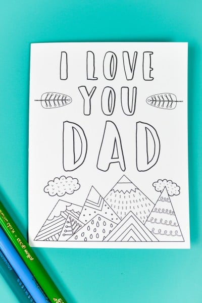 Colored pencils lying next to a printable, coloring Father's Day Card