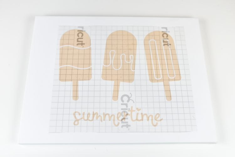 A close up of a cut file of three popsicle images and the word summertime on it