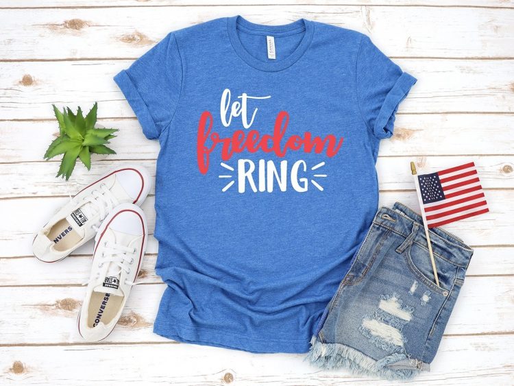 A succulent, tennis shoes, blue jeans shorts, and a blue t-shirt with the saying, "Let Freedom Ring"