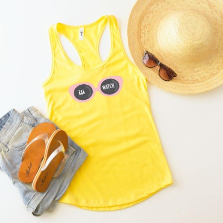 A yellow tank top with an image of a pair of pink sunglasses that say Bae Watch on the lenses