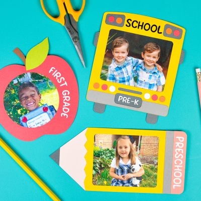 A pair of scissors, two pencils and three pictures encased in school themed frames
