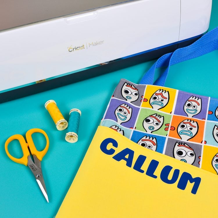 Cricut Maker with tote bag made of Toy Story "Forky" Fabric with the name Callum on the bag.
