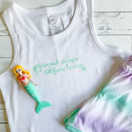 A white tank top that says Mermaid Wishes, Starfish Kissed