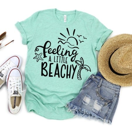 A mint green t-shirt that says, Feeling a Little Beachy