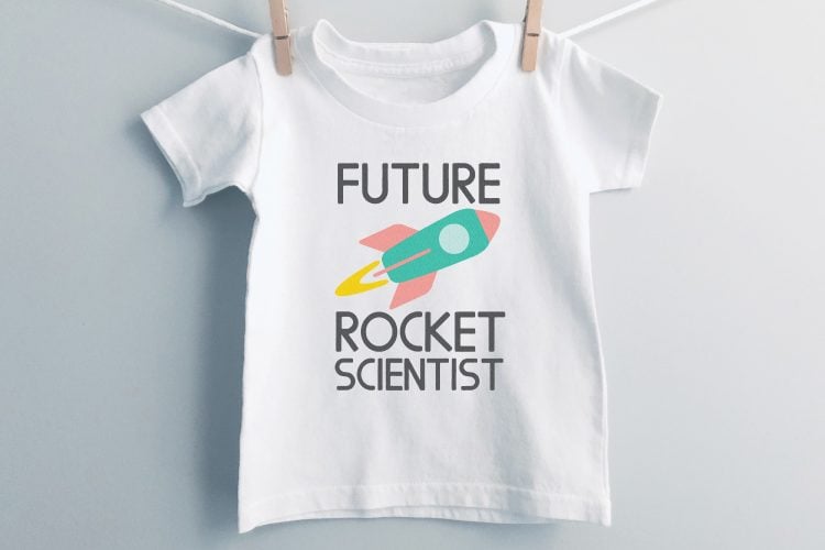 White t-shirt hanging with clothespins on a clothesline and the shirt is decorated with a rocket with the saying, \"Future Rocket Scientist\"
