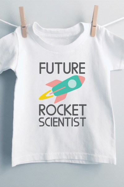 White t-shirt hanging with clothespins on a clothesline and the shirt is decorated with a rocket with the saying, "Future Rocket Scientist"
