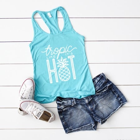 An aqua colored tank top that says Tropic Like It's Hot