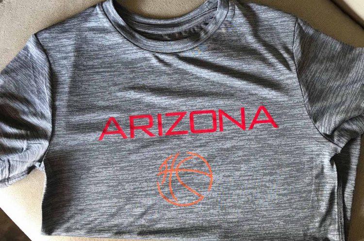 A grey athletic shirt decorated with a basketball image and the text Arizona
