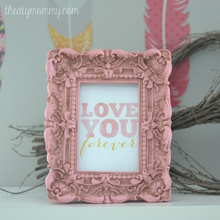 A decorative pink frame with a saying, \"Love you Forever\"